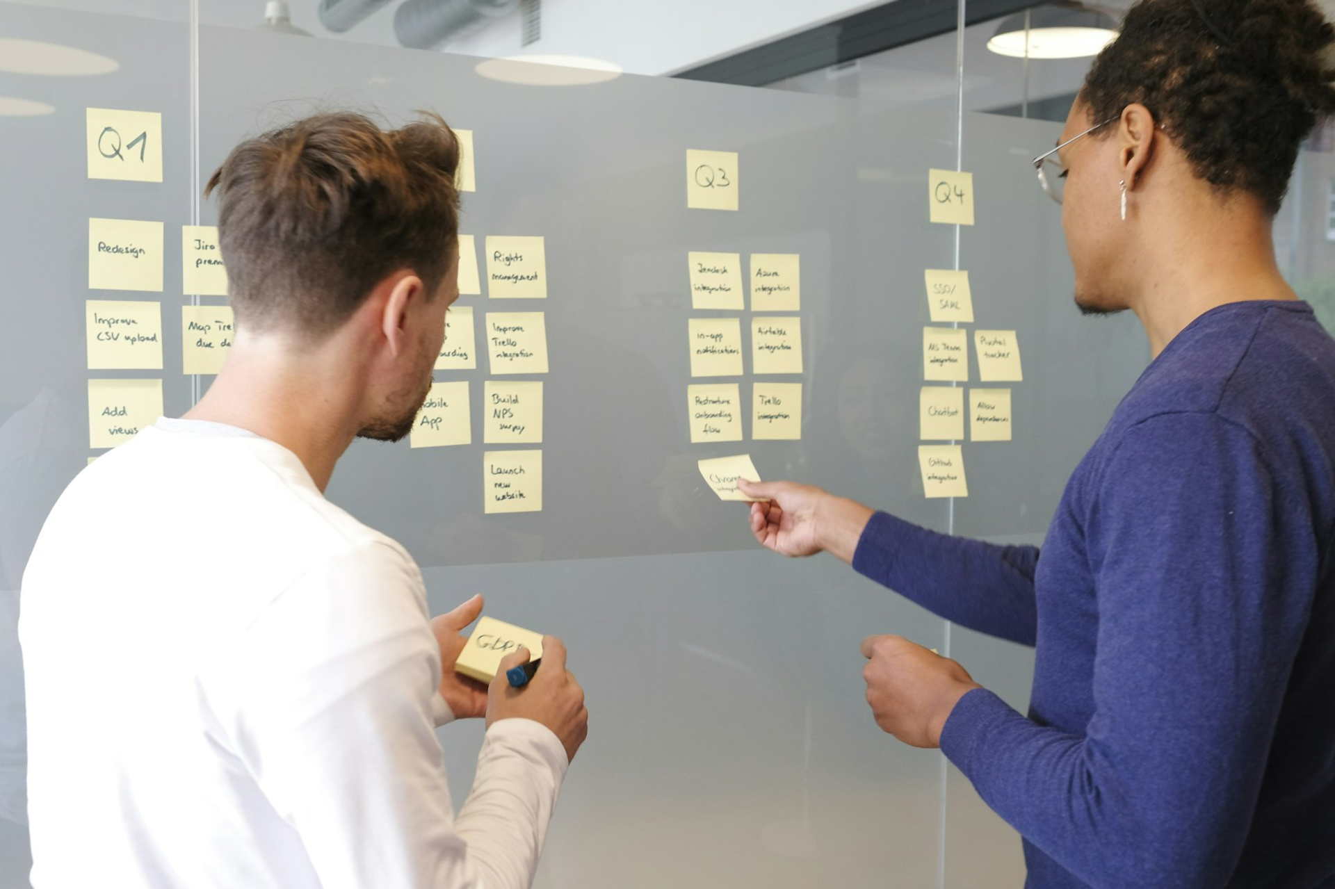 man in blue long sleeve shirt holding smartphone